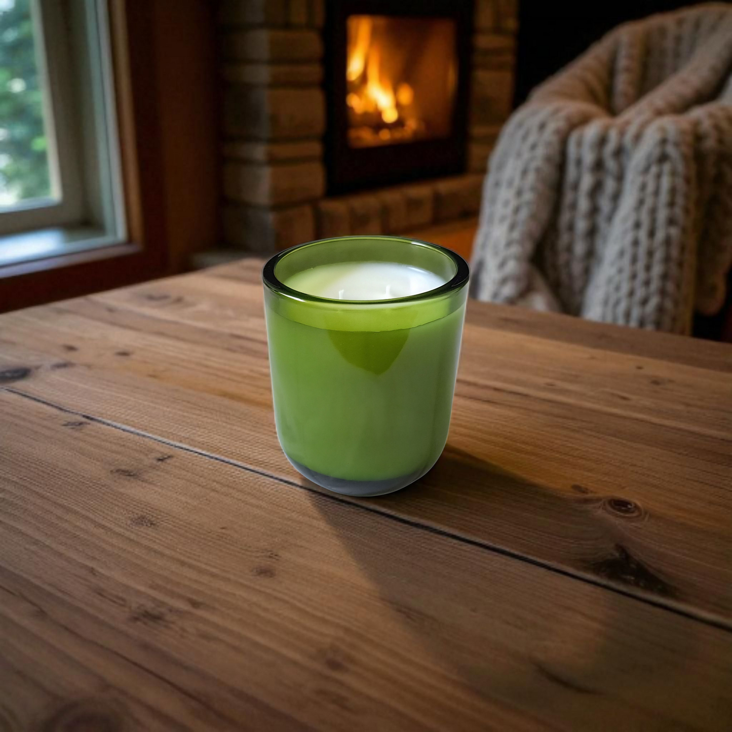 Fogborn candle on wooden table and fireplace with cozy background