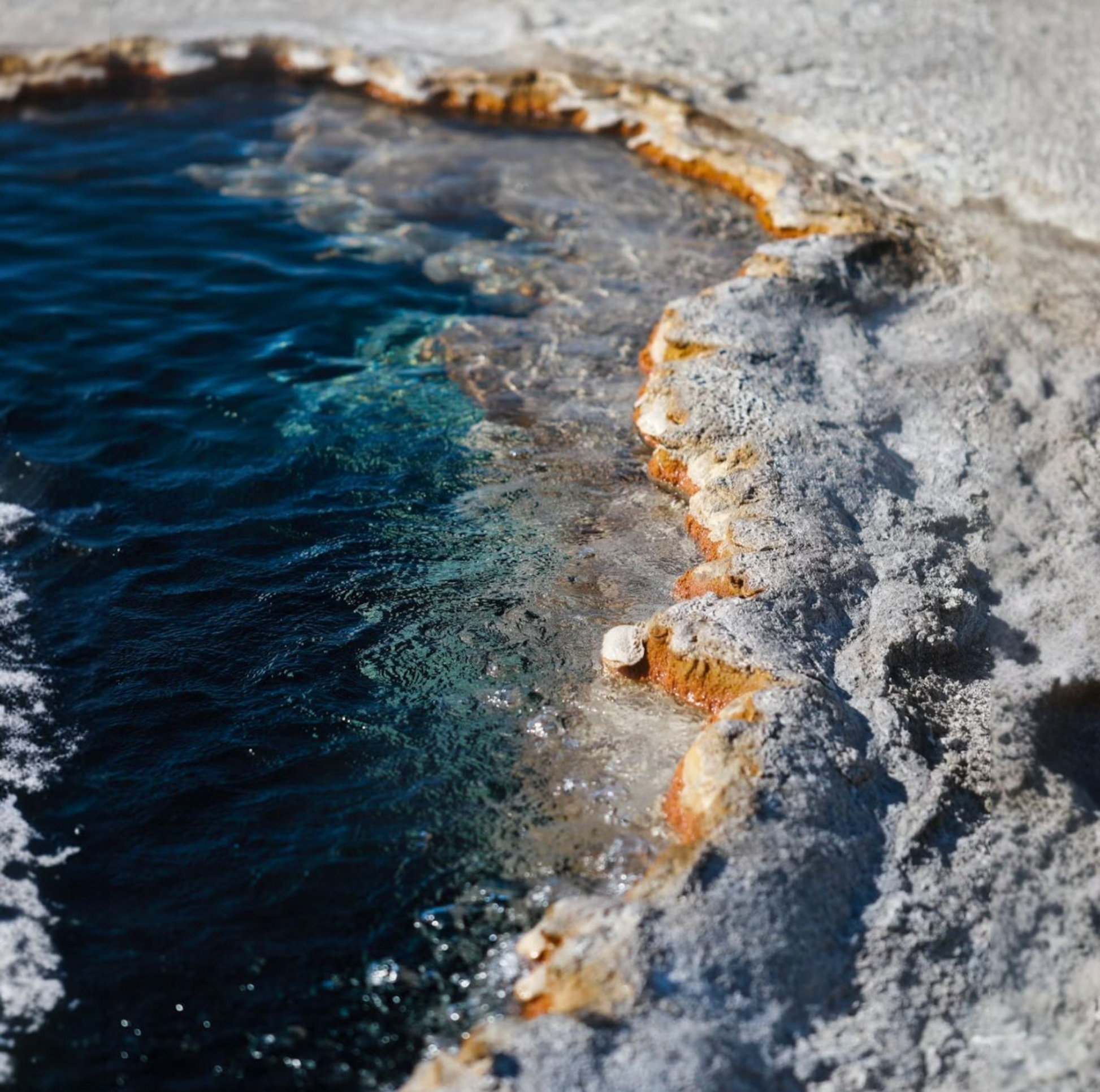 Close-up of blue sea with mineral salt deposits and clear water