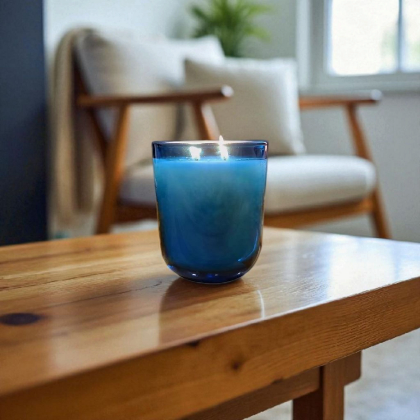 Blue Saltmere candle on a wooden surface with a blurred background