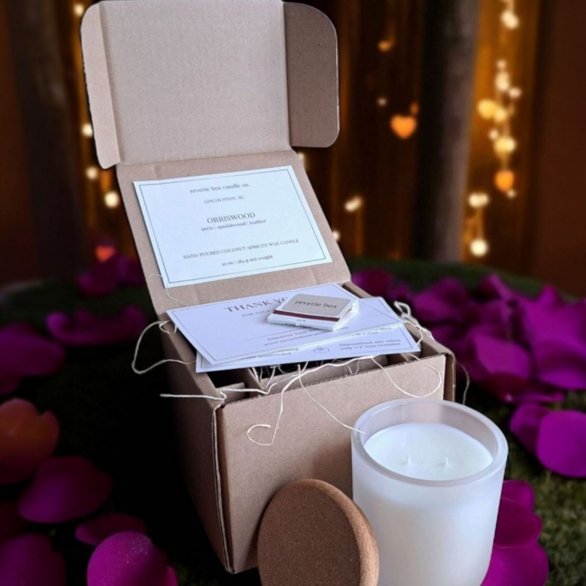 White Orriswood candle and box with  cards against scenic background